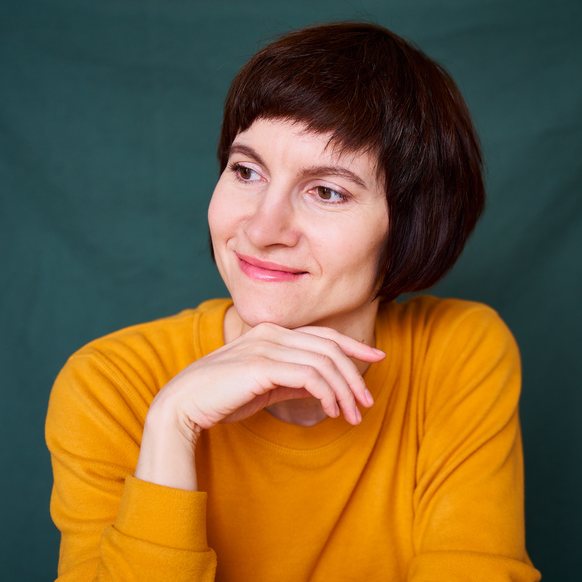 Home smiling mature brunette woman looking away playful and defiant close up face.jpg